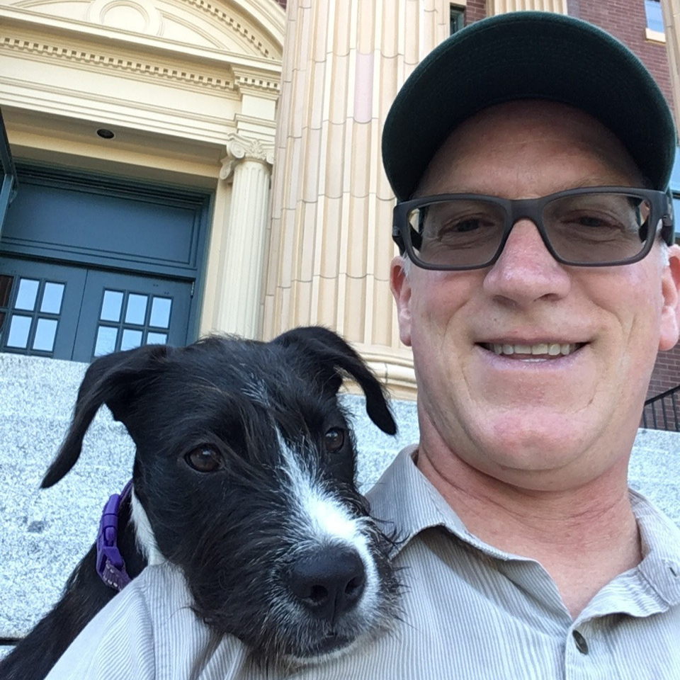 Dr. Linneman with his dog Archie in front of Edens Hall
