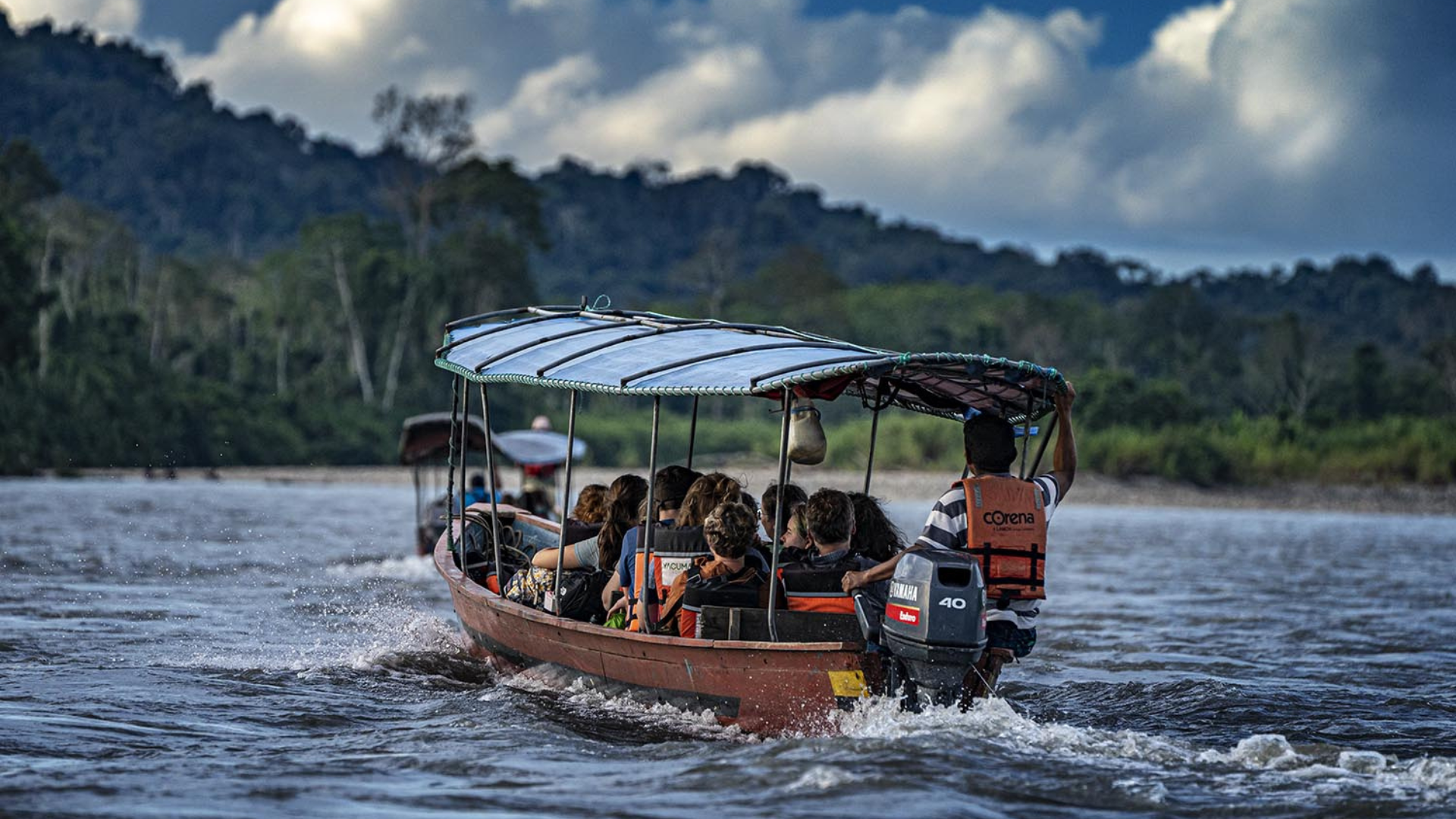Students on a boat riding through the Amazon
