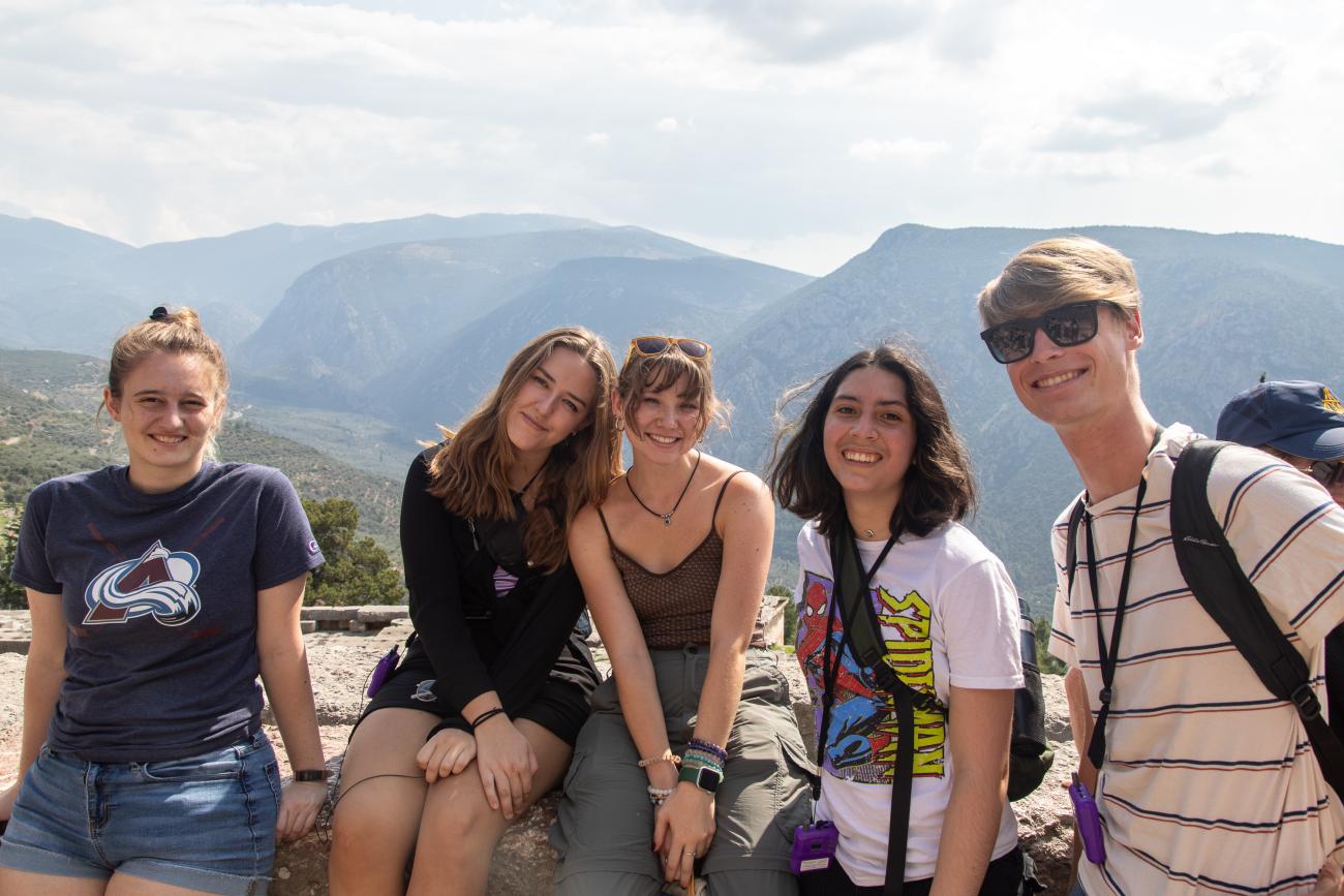 Students Sam, Colette, Sophie, Rye, and Kai smile at Delphi