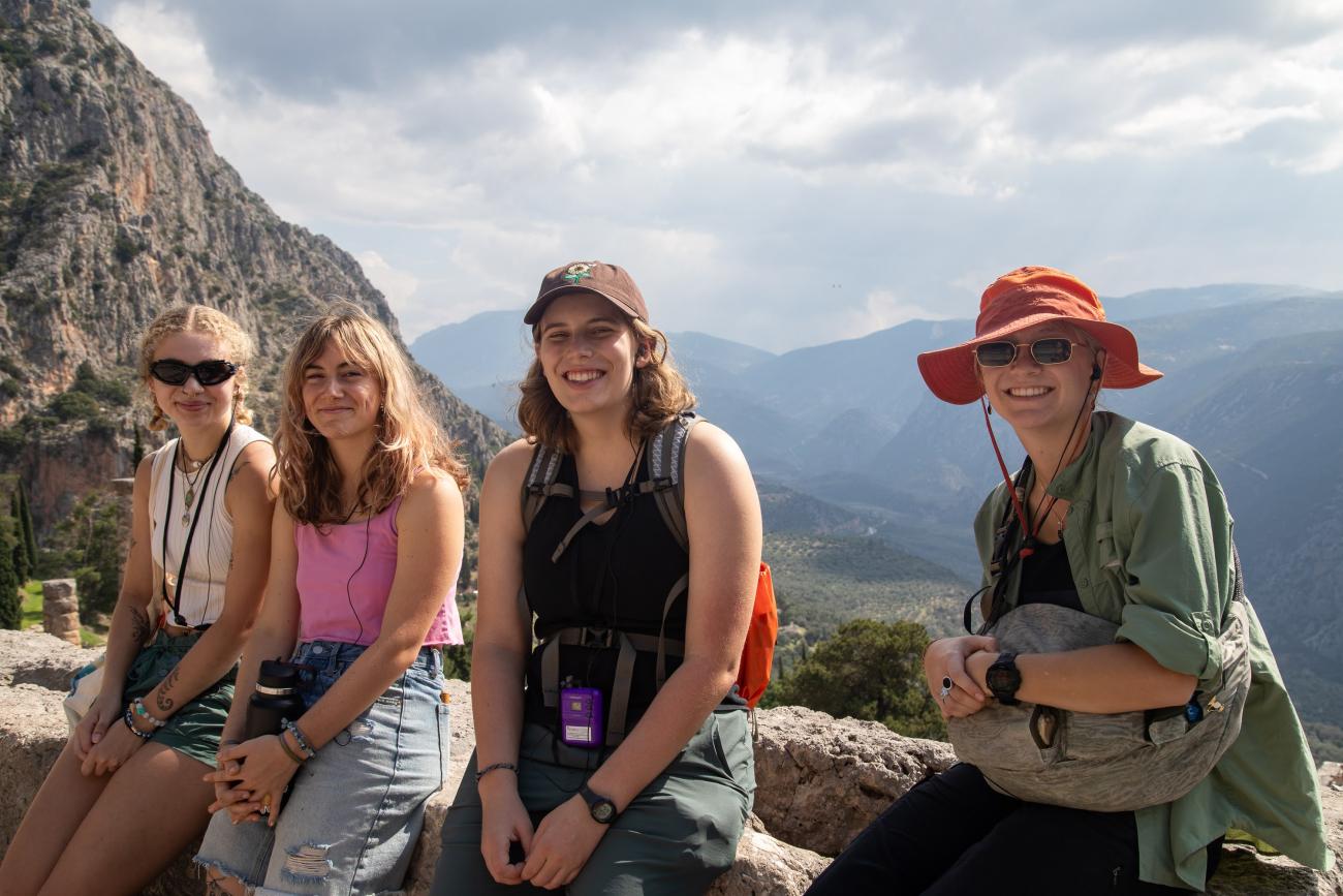 Honors students Taylor, Zoe, Grace, and Anna smiling at the site of Delphi