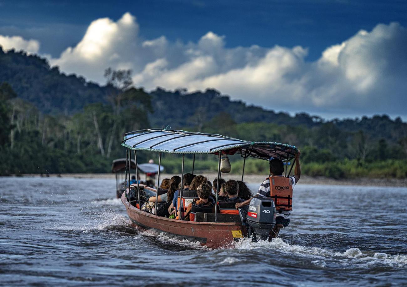 Students ride in a boat on the Amazon river