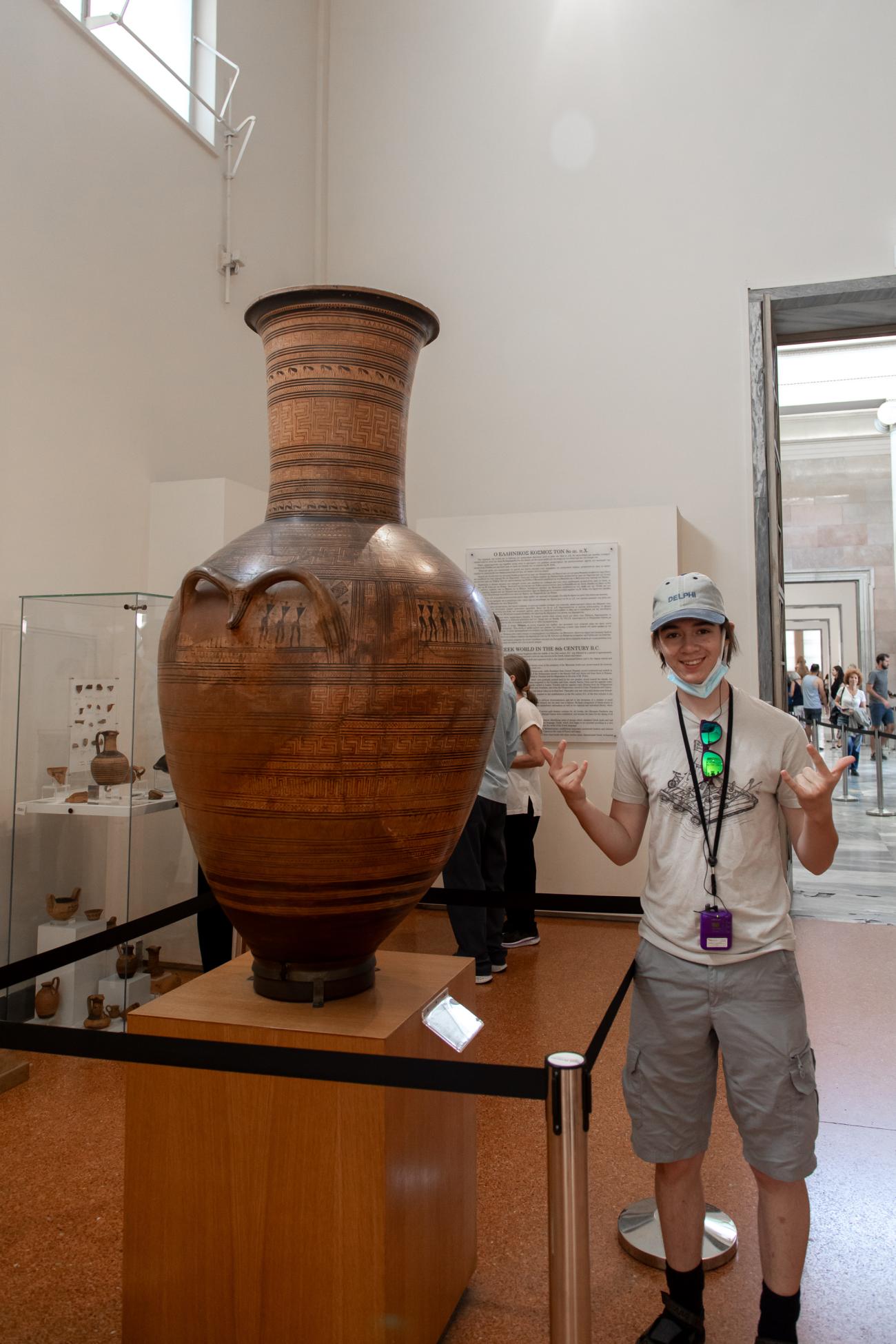 Sam stands next to a large vase in the National Archaeological Museum in Athens